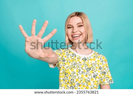 Photo of lovely positive woman with bob hairstyle dressed t-shirt palm showing five fingers to you isolated on teal color background