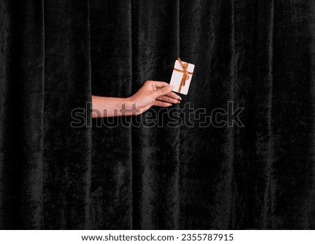 Golden Ticket to Discounts: A Hand Extends the Joy of Black Friday Shopping Royalty-Free Stock Photo #2355787915