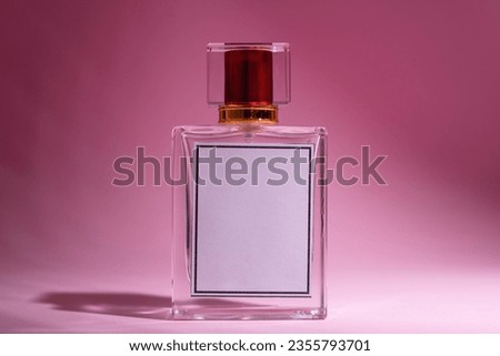 A photo of a perfume bottle with a blank space to write the brand name.