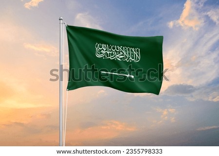 Saudi Arabia flag waving on sundown sky Royalty-Free Stock Photo #2355798333
