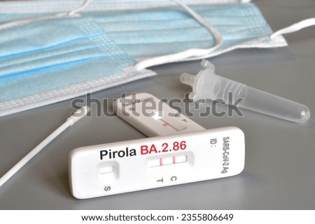 SARS‑CoV‑2 antigen test kit for self testing with positive result with text Pirola BA.2.86 on grey background. Close-up. Concept for the new Covid 19 Pirola Variant Royalty-Free Stock Photo #2355806649