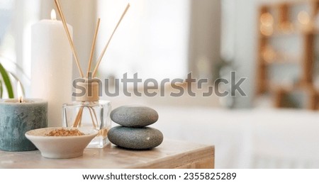 Spa, rock and candle to relax in a room with atmosphere, mood or ambience in a health club. Wellness, luxury and treatment with still life objects on a table in a clinic for rest and relaxation Royalty-Free Stock Photo #2355825289