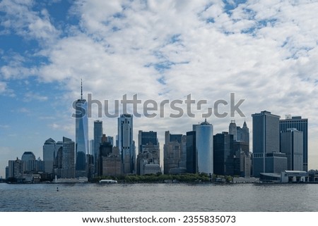 The Manhattan skyline as viewed from the sea, on a partially cloudy day.