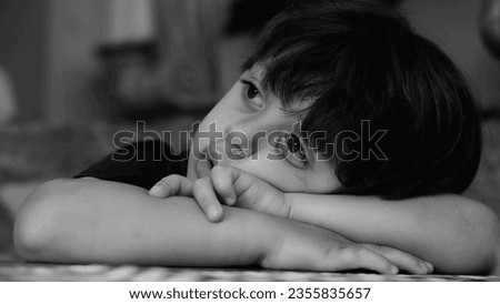 Monochrome Portrait of Forlorn Boy, Overwhelmed by Gloom and Boredom, Black and White Depiction of Youngster Wrestling with Sadness and Ennui