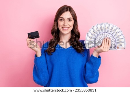 Photo portrait of attractive young woman hold shopping money fan credit card dressed stylish blue clothes isolated on pink color background