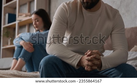 Annoyed Caucasian husband sit apart on bed with offended wife keep silence after fight family quarrel married couple woman man arguing misunderstanding breakup divorce relationship crisis in bedroom Royalty-Free Stock Photo #2355864167