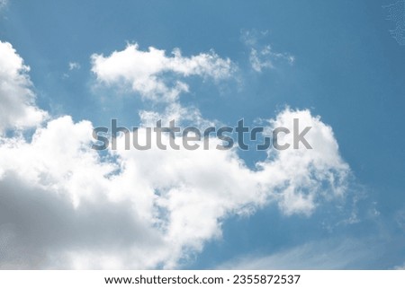Photo of white clouds in a clear blue sky