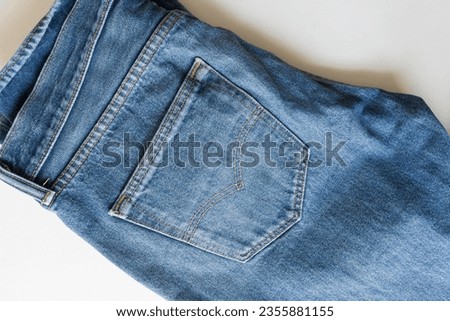 blue denim with fading isolated on white and photographed from above in ambient or available light