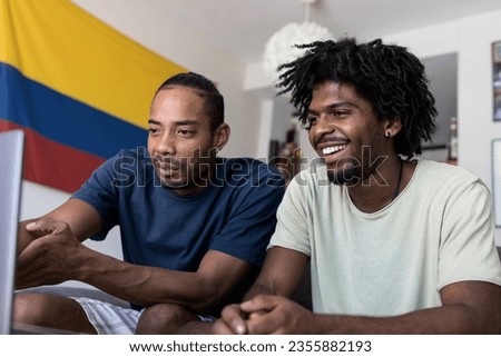 Two Colombian boys looking at the computer screen. Stock photo