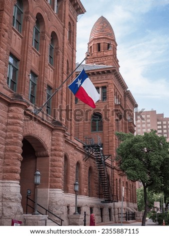 Bexar County Courthouse in San Antonio, Texas, with waving Texan Flag outside.
