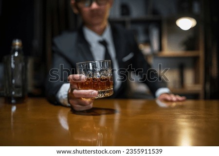 Businessmen in suits drinking whiskey