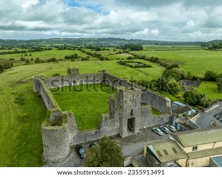 Aerial view of Liscarroll Castle 13th-century Hiberno-Norman fortress in Cork county with round corner towers and imposing Gothic gate house