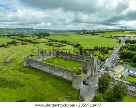 Aerial view of Liscarroll Castle 13th-century Hiberno-Norman fortress in Cork county with round corner towers and imposing Gothic gate house