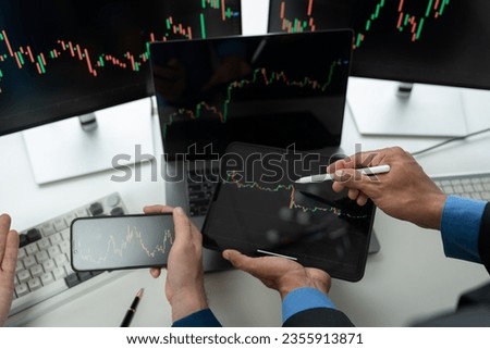 Business team investors discuss stock trading chart growth research report Stock market price using PC computer tablet looking at screen Investment strategy analysis chart choosing the right direction