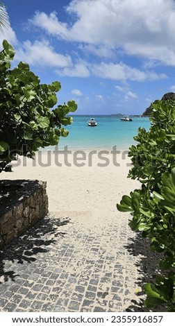 Picturesque Walkway to Public Beach, surrounded by Lush Trees, White Sand and Turquoise Waters on a Sunny Day on Caribbean Island 