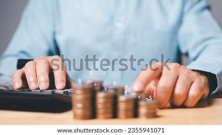 A man sat at his desk, calculating the potential returns on his investment in a new business. He dreamed of growing his wealth and building a better future for himself and his family. Royalty-Free Stock Photo #2355941071