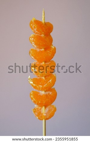 Tanghulu, a fruit skewer Korean snack candy coated with sugar syrup Royalty-Free Stock Photo #2355951855