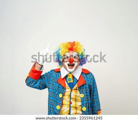 Mr Clown. Portrait of Funny face Clown man in colorful uniform standing and thinking. Happy expression male bozo in various pose on isolated background.