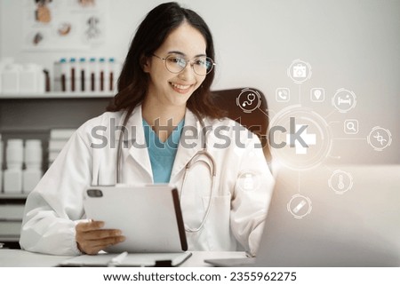 Female doctor working on desk with laptop computer, tablet and paperwork in the office. Medical and doctor concept.