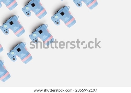 Pattern with camera on pastel color background, top view