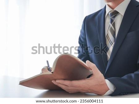 Businessman image background writing in notebook