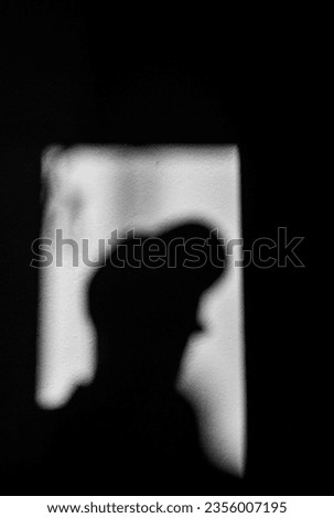 human figure falling into shadow, black and white background