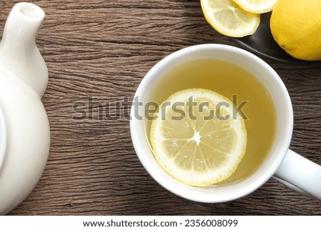 Top view, A cup of tea with fresh lemon on wooden table. copy space. herbal drink concept