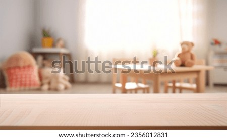 Empty wooden table in baby room interior Royalty-Free Stock Photo #2356012831