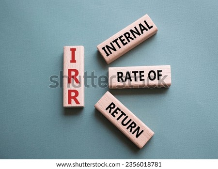 IRR - Internal Rate of Return symbol. Concept word IRR on wooden cubes. Beautiful grey green background. Business and IRR concept. Copy space.