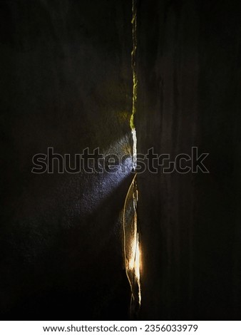 The light coming through the cracks looks nice and unique. Royalty-Free Stock Photo #2356033979