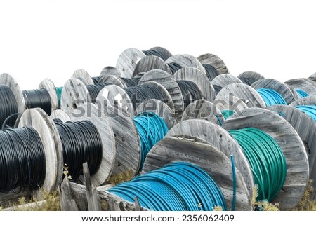 Big pile of wooden cable drums isolated on white Royalty-Free Stock Photo #2356062409