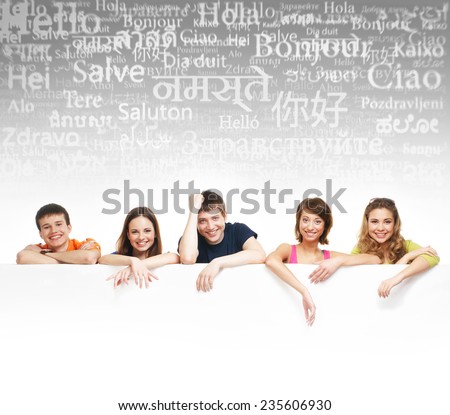 Group of teenagers over the background with the many words from the different languages (language school concept)