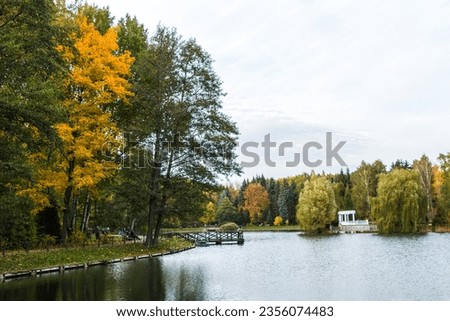 beautiful autumn landscape, colorful trees are reflected in the lake