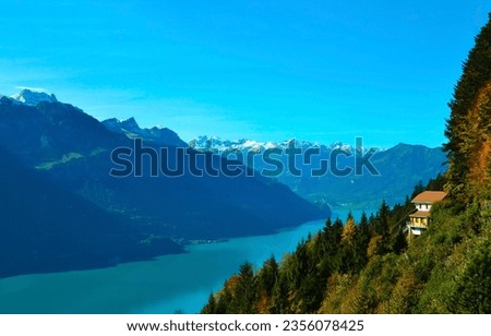 House on a mountainside by a mountain river. Mountain house by mountain river. Mountain landscape Royalty-Free Stock Photo #2356078425