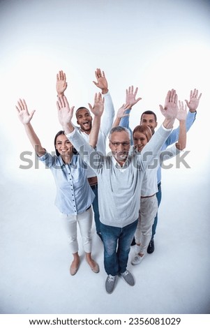 Full length portrait of beautiful business people in smart casual wear raising their hands, looking at camera and smiling, isolated on white