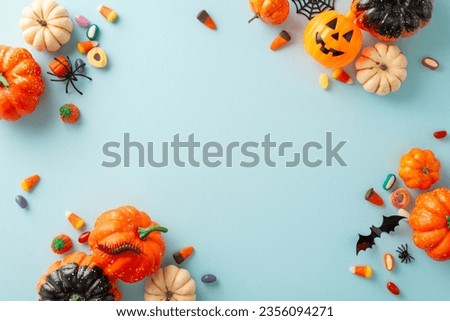 Fun-filled kid's trick or treat tradition. Bird's-eye view image of a pumpkins, candies, and Halloween decorations on light blue isolated surface, ideal for text or advert incorporation