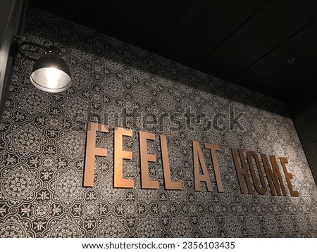 Typical design for feel at home sign board on the wall.