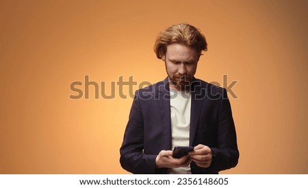 Charismatic businessman uses gadget, reads blogger post.