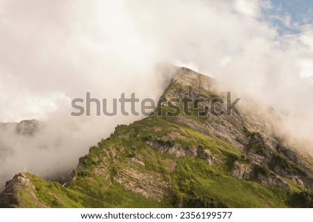 Thick clouds over the mountains on a sunny summer day