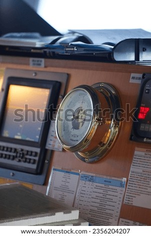 barge ship captain rudder and barometer image close up Royalty-Free Stock Photo #2356204207