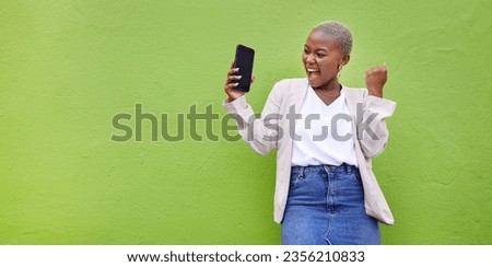 Woman, celebrate and phone screen with mockup by a wall or green background with wow advertising. Excited African person or winner with a smartphone for competition, promotion or website banner space