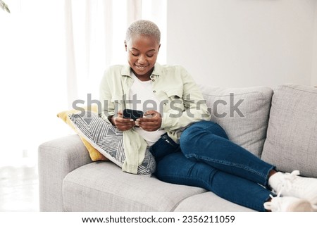 Happy black woman, smartphone and typing on sofa for social media post, digital contact and reading notification. Cellphone, mobile games and scroll online shopping app to search subscription at home