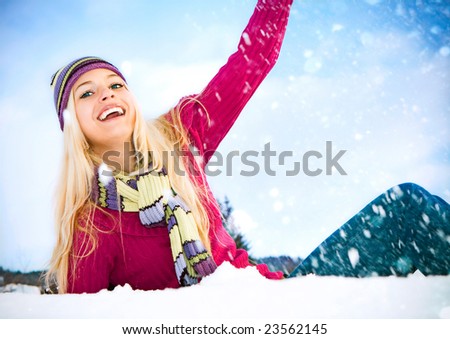 young blond cheerful girl in the snow