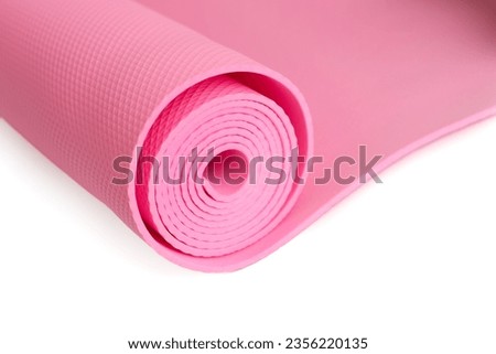 A pink yoga mat isolated on a white background. Сoncept of fitness equipment.