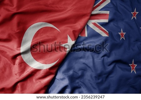 big waving national colorful flag of turkey and national flag of new zealand . macro