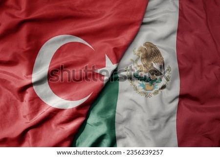 big waving national colorful flag of turkey and national flag of mexico . macro