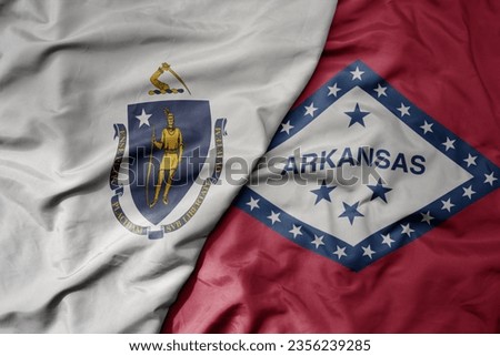 big waving colorful national flag of arkansas state and flag of massachusetts state . macro