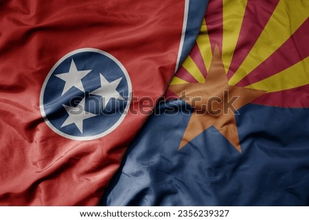 big waving colorful national flag of arizona state and flag of tennessee state . macro