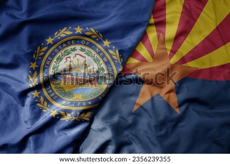 big waving colorful national flag of arizona state and flag of new hampshire state . macro