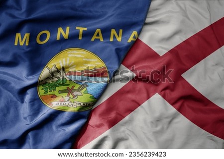 big waving colorful national flag of alabama state and flag of montana state . macro
